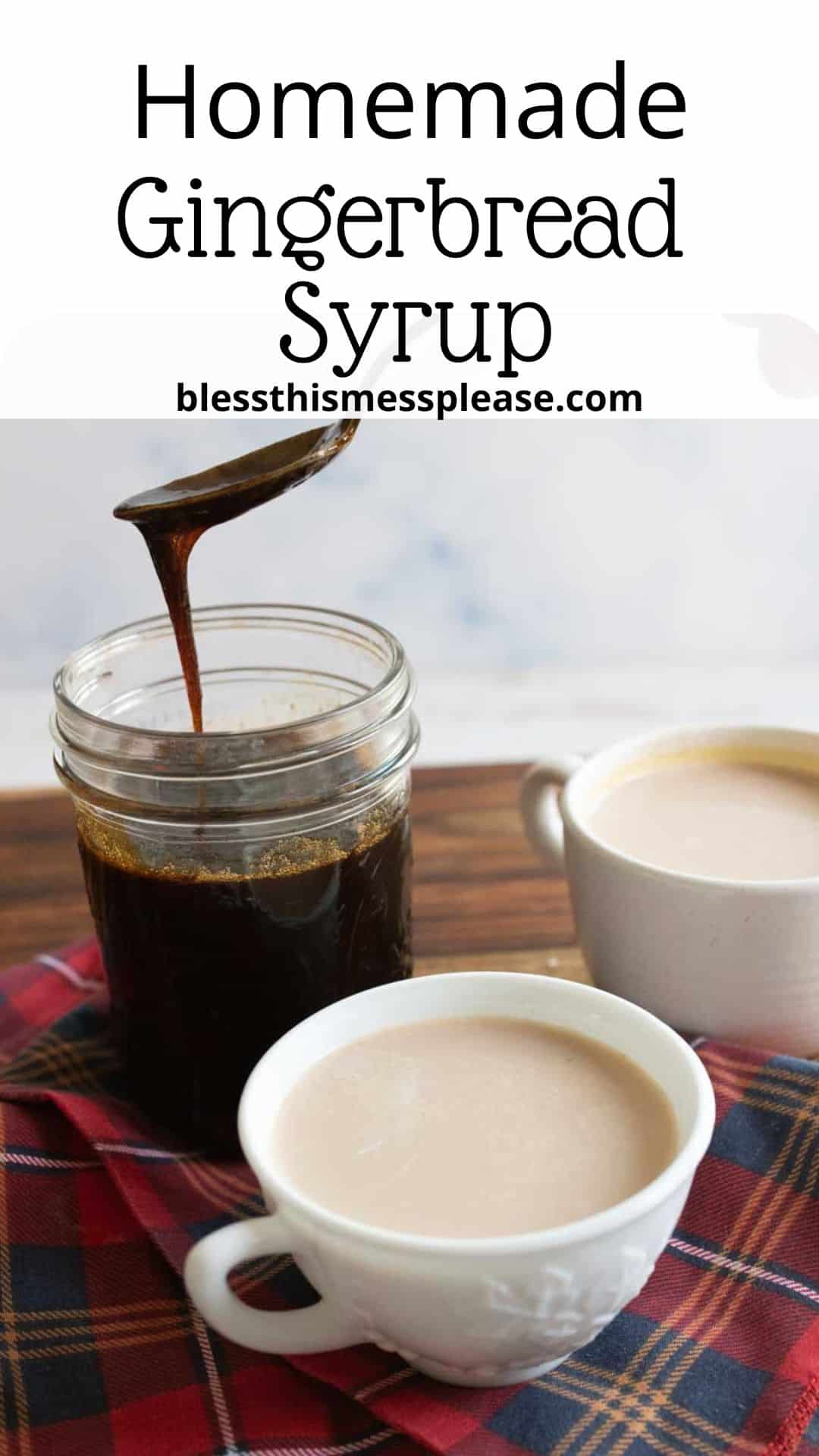 A jar of homemade gingerbread syrup sits on a wooden surface, with syrup being poured. Two cups of coffee or tea are on a plaid cloth next to it. The text reads Homemade Gingerbread Syrup and blessthismessplease.com.