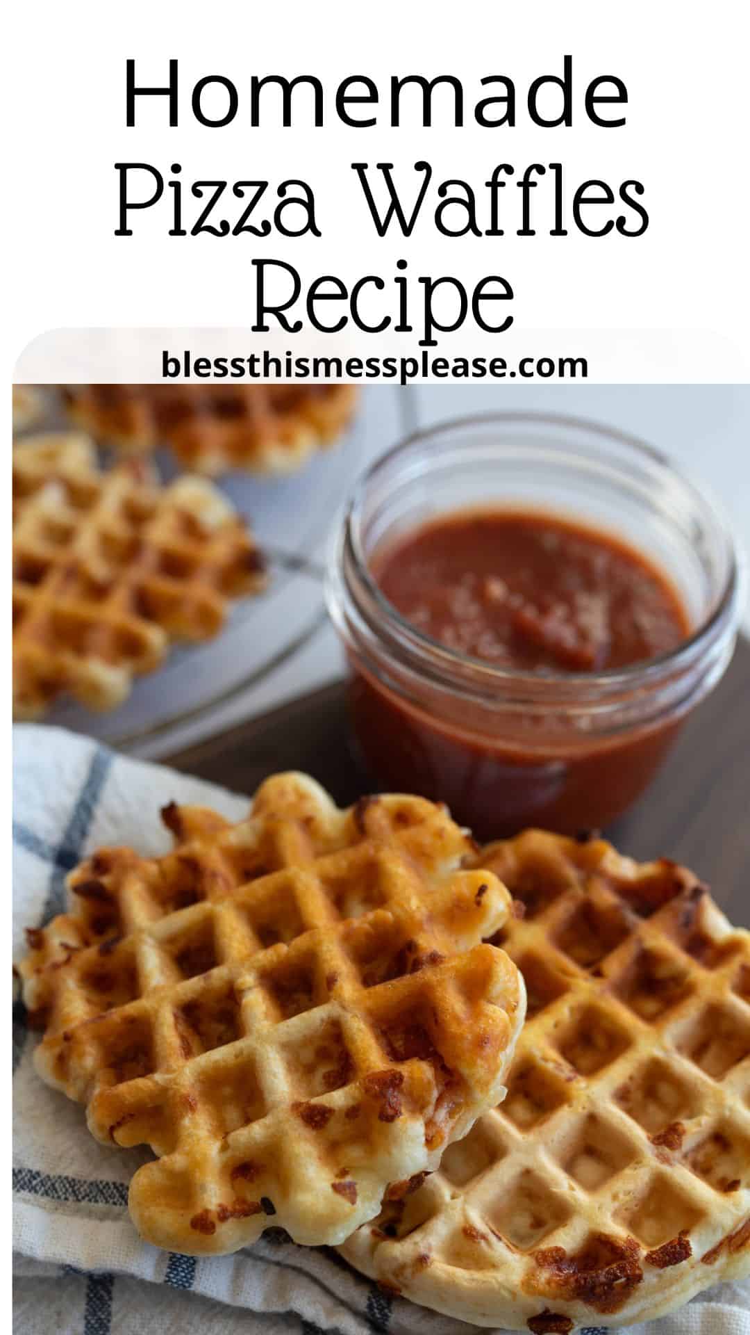 A plate with homemade pizza waffles, golden brown and crispy, arranged on a towel. A small glass jar filled with marinara sauce is nearby. Text at the top reads Homemade Pizza Waffles Recipe and blessthismessplease.com.