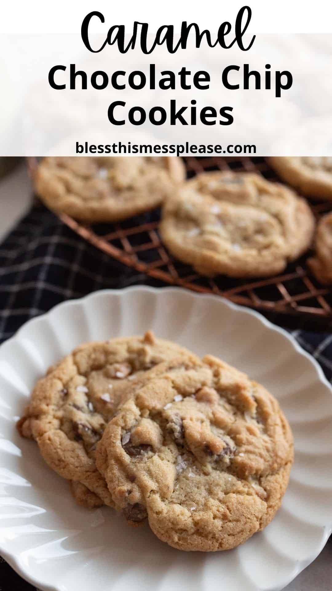 Two caramel chocolate chip cookies on a white plate with more cookies cooling on a wire rack.