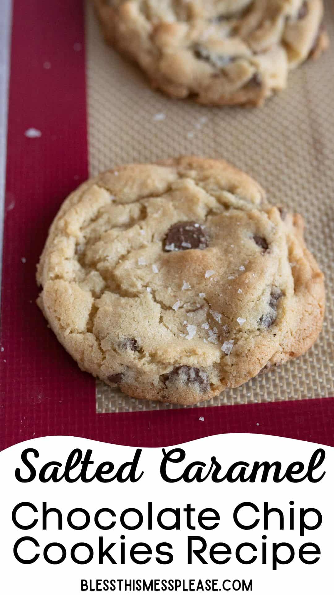 Close-up of a salted caramel chocolate chip cookie on a baking mat. The cookie is golden brown with visible chocolate chips and a sprinkle of salt. Text below reads: Salted Caramel Chocolate Chip Cookies Recipe from BLESSTHISMESSPLEASE.com.